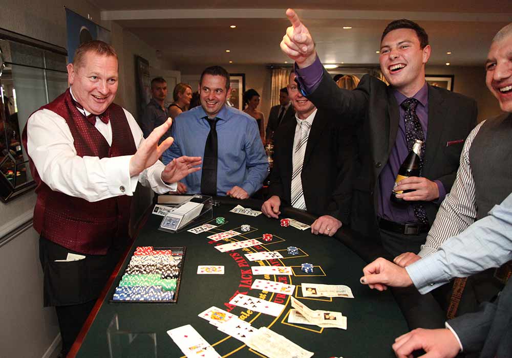 Pier Fun Casinos croupier entertaining guests at a card table Pier Fun Casinos croupier entertaining guests at a card table